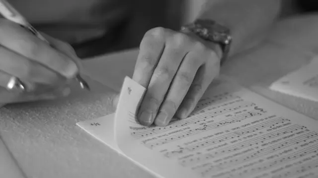 person writing on white paper