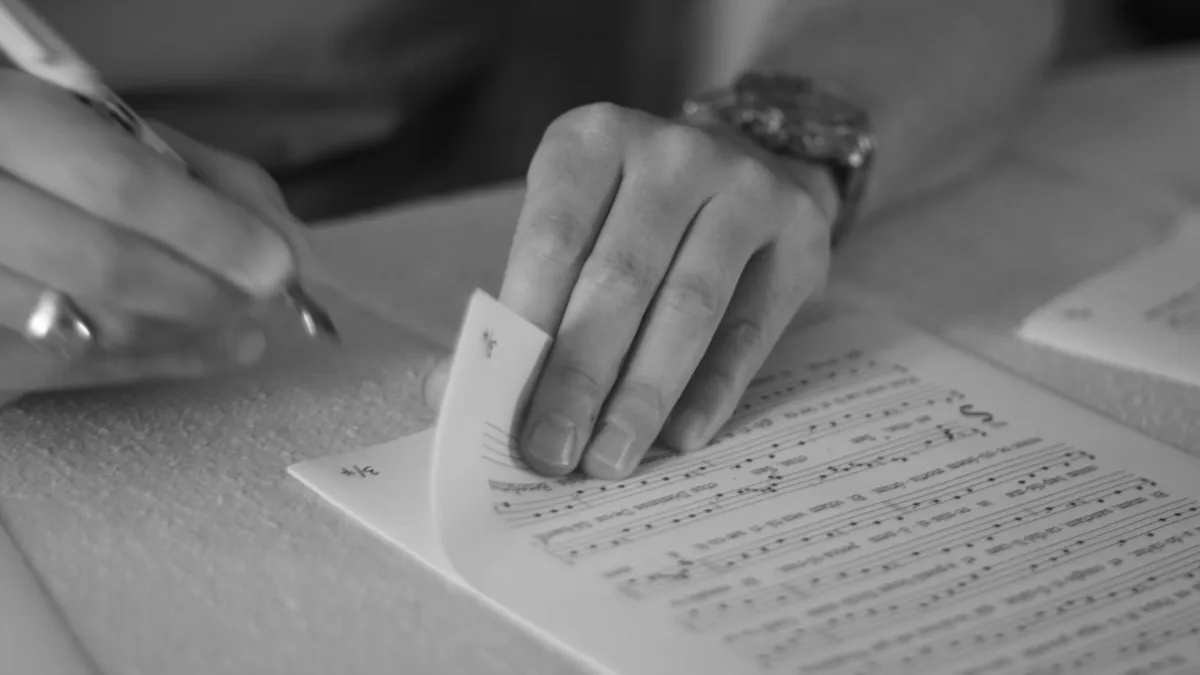 person writing on white paper